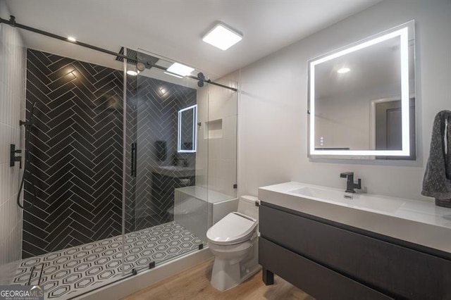 bathroom featuring hardwood / wood-style flooring, vanity, toilet, and an enclosed shower