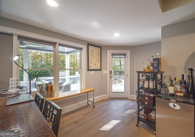 entryway featuring bar area and light hardwood / wood-style flooring