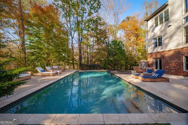 view of swimming pool with a patio area