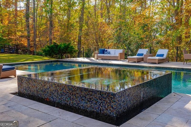 view of pool with a patio and an outdoor hangout area