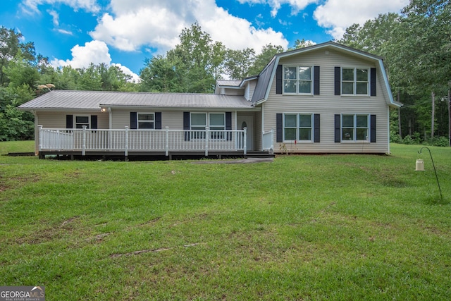 view of front of house with a front yard and a wooden deck