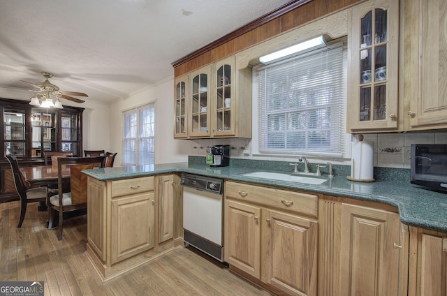 kitchen featuring white dishwasher, sink, ceiling fan, light hardwood / wood-style floors, and kitchen peninsula