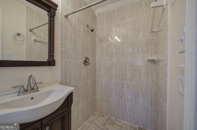 bathroom featuring vanity and tiled shower