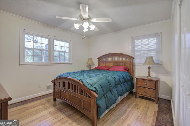 bedroom featuring ceiling fan, light wood-type flooring, and ornamental molding