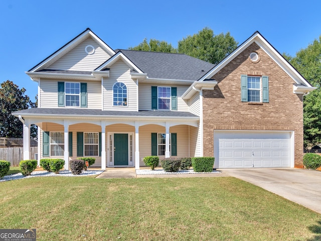 view of front of house featuring a porch, a garage, and a front lawn