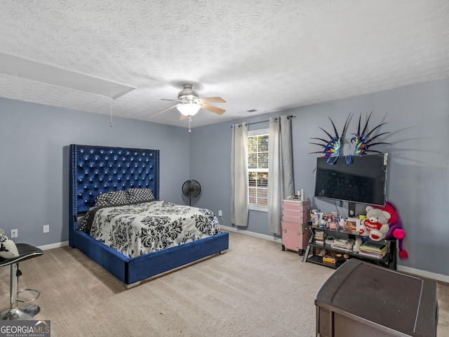 bedroom featuring ceiling fan, carpet, and a textured ceiling