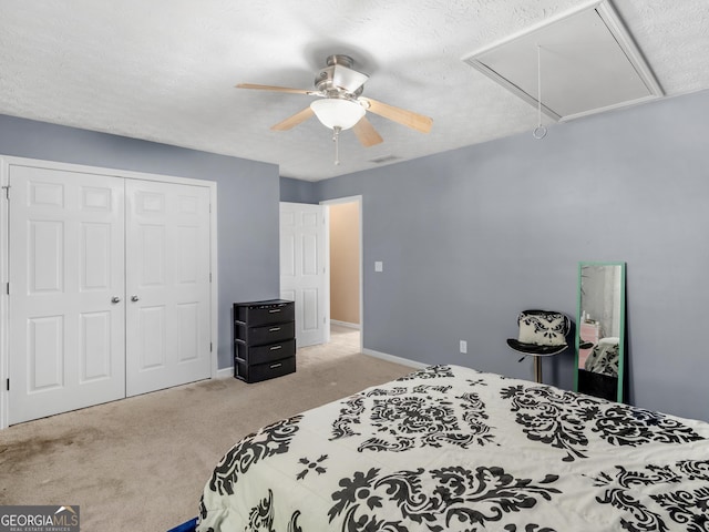 carpeted bedroom featuring a textured ceiling, a closet, and ceiling fan