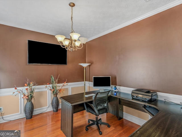 home office with hardwood / wood-style flooring, a notable chandelier, crown molding, and a textured ceiling