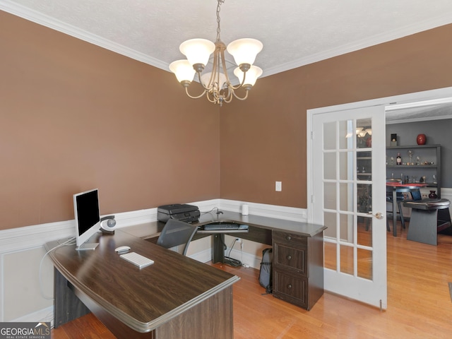 office space featuring french doors, crown molding, light hardwood / wood-style flooring, a textured ceiling, and a notable chandelier