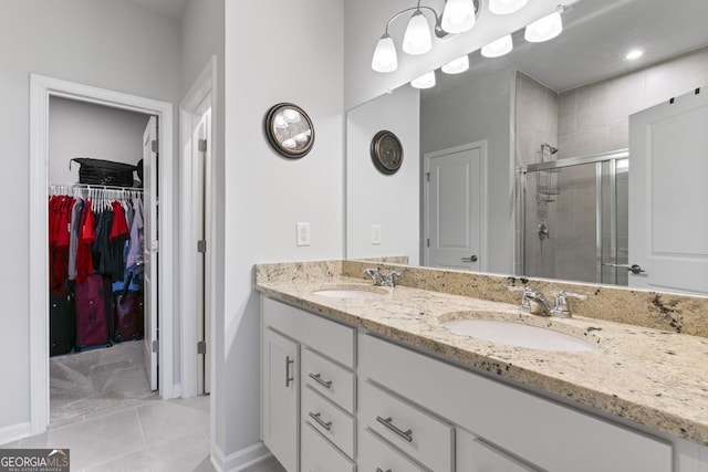 bathroom with tile patterned floors, vanity, and an enclosed shower