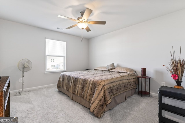 bedroom featuring light carpet and ceiling fan