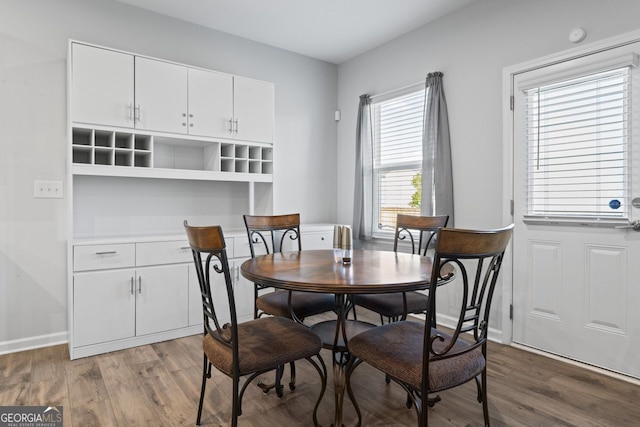 dining space with dark hardwood / wood-style flooring