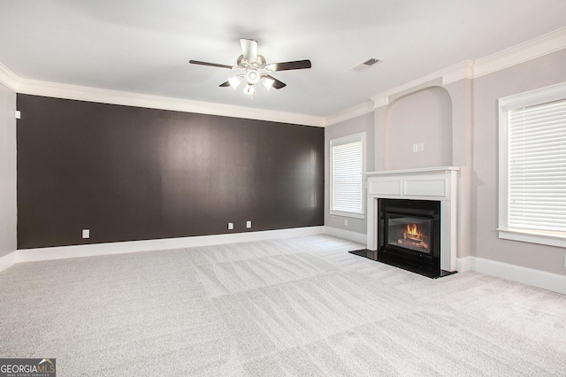 unfurnished living room with ceiling fan, light colored carpet, and crown molding