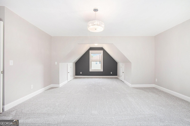 additional living space with light colored carpet and lofted ceiling