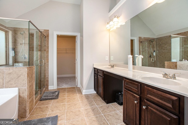 bathroom featuring vanity, vaulted ceiling, tile patterned floors, and independent shower and bath