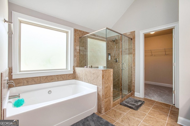 bathroom featuring tile patterned flooring, lofted ceiling, and independent shower and bath