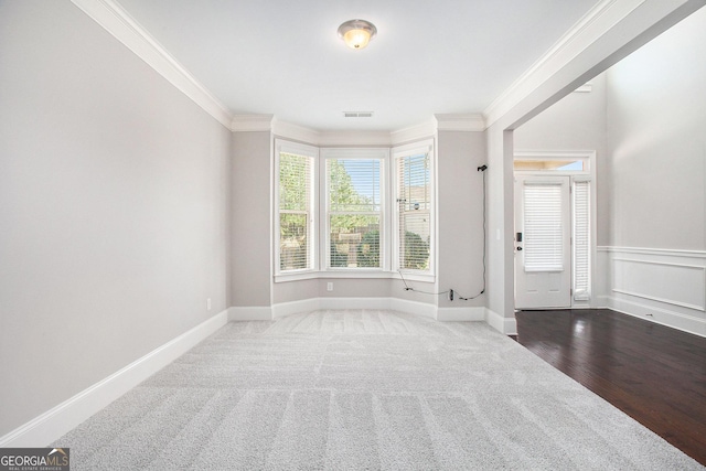 carpeted empty room with ornamental molding