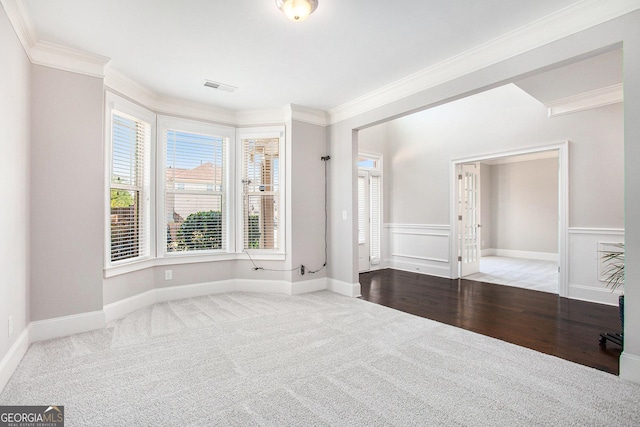 unfurnished room featuring hardwood / wood-style floors and ornamental molding