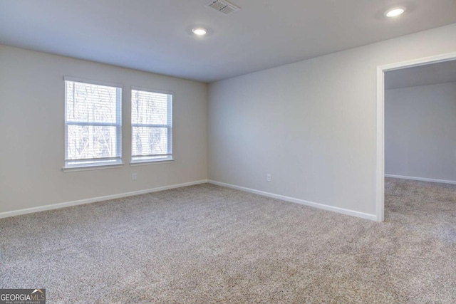 unfurnished room featuring light carpet