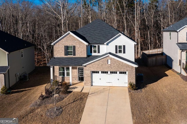 view of property featuring central AC unit and a garage