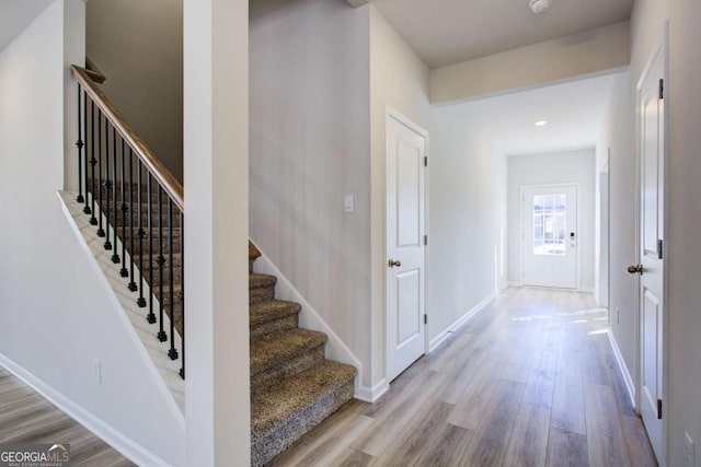 stairs featuring hardwood / wood-style flooring