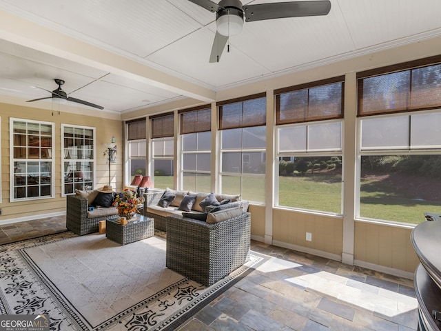 sunroom / solarium featuring ceiling fan