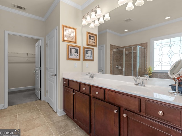 bathroom with tile patterned flooring, vanity, a shower with door, and ornamental molding