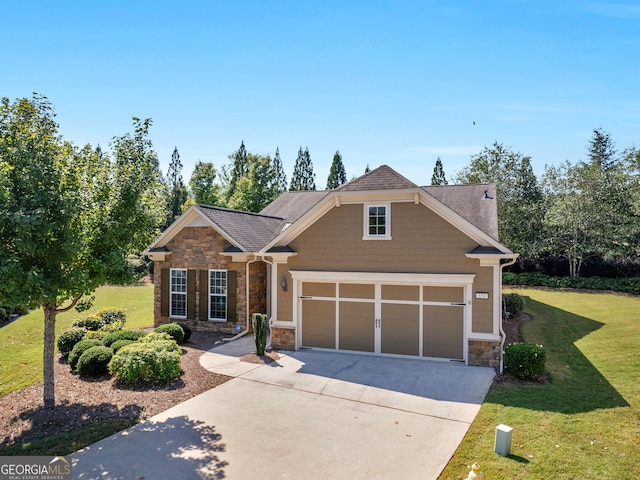 craftsman inspired home featuring a garage and a front lawn