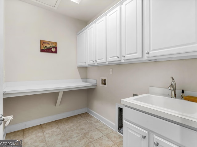 washroom with sink, cabinets, and washer hookup