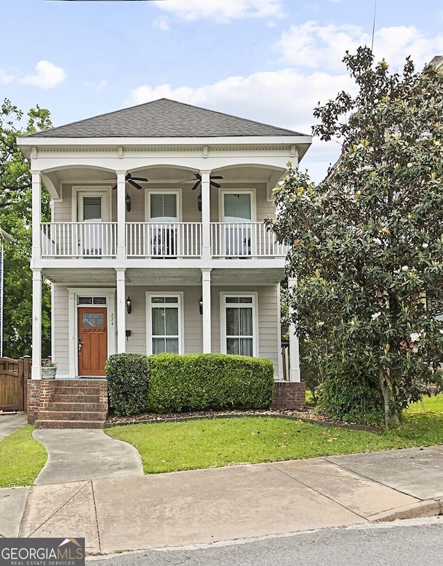 view of front of home with a balcony and ceiling fan