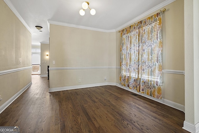 spare room featuring dark wood-type flooring, an inviting chandelier, and crown molding