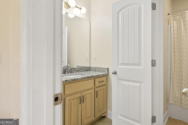 bathroom with tile patterned floors, curtained shower, and vanity