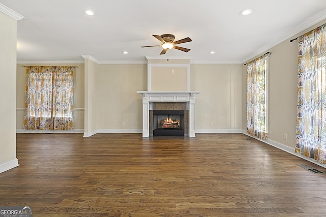 unfurnished living room with a wealth of natural light, crown molding, ceiling fan, and dark wood-type flooring