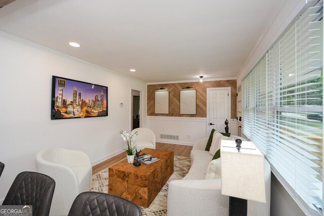 living room featuring hardwood / wood-style floors and crown molding