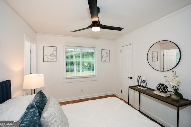 bedroom featuring hardwood / wood-style flooring, ceiling fan, and crown molding