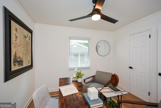 office space with hardwood / wood-style floors, baseboard heating, ceiling fan, and crown molding