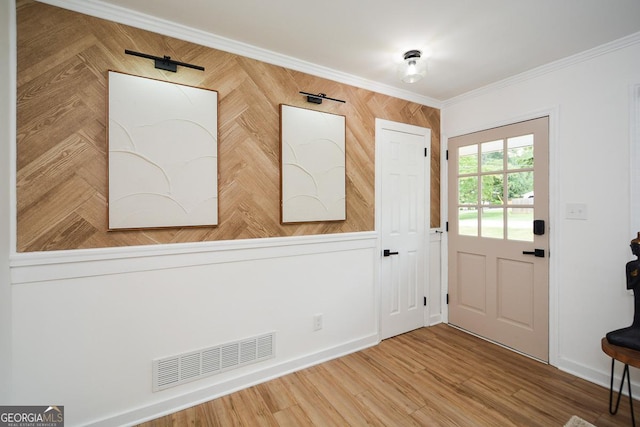 entrance foyer featuring hardwood / wood-style floors, ornamental molding, and wood walls