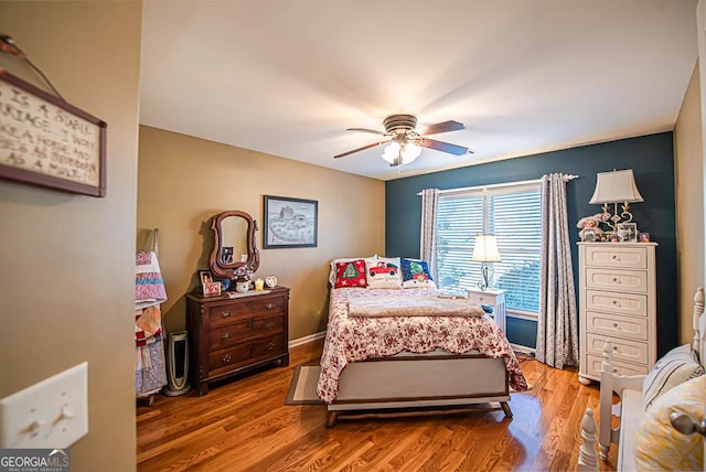 bedroom with hardwood / wood-style floors and ceiling fan