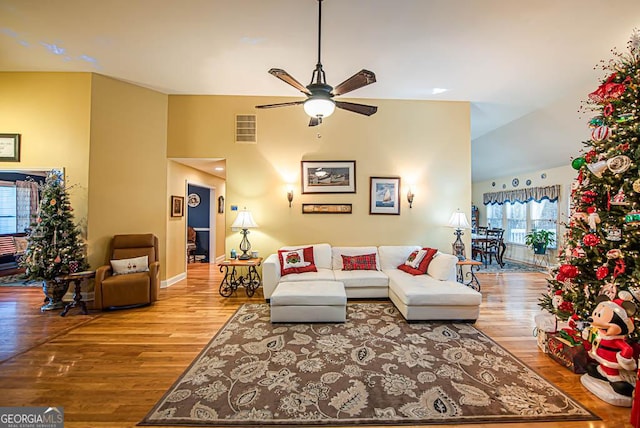 living room featuring hardwood / wood-style floors and ceiling fan