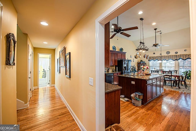 hallway with hardwood / wood-style floors and sink