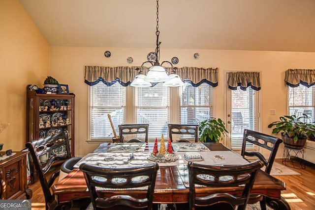 dining room featuring hardwood / wood-style flooring and an inviting chandelier