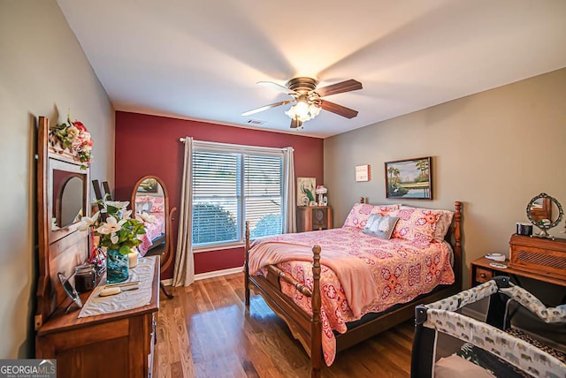 bedroom featuring hardwood / wood-style flooring and ceiling fan