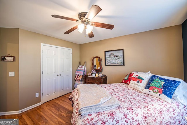 bedroom featuring ceiling fan, a closet, and hardwood / wood-style flooring