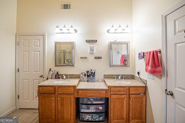 bathroom with tile patterned flooring and vanity