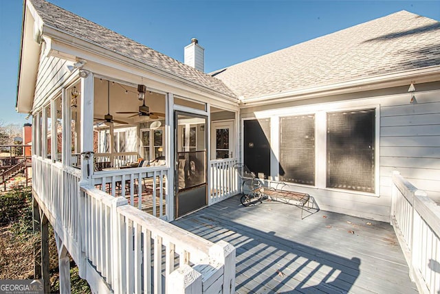 wooden terrace featuring a sunroom and ceiling fan