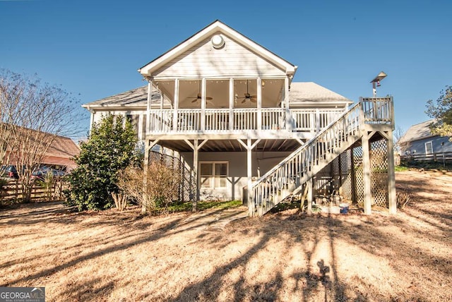 rear view of house featuring ceiling fan and a deck