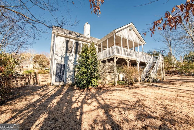 back of house with ceiling fan