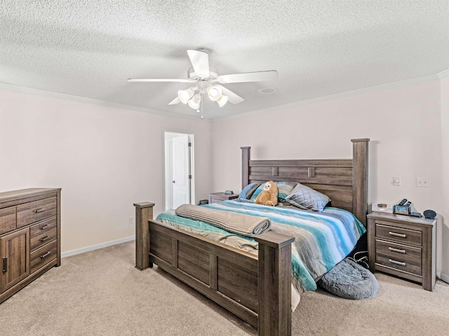 carpeted bedroom with a textured ceiling, ceiling fan, and crown molding