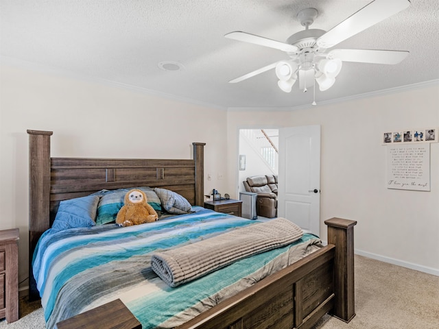 carpeted bedroom featuring a textured ceiling, ceiling fan, and ornamental molding