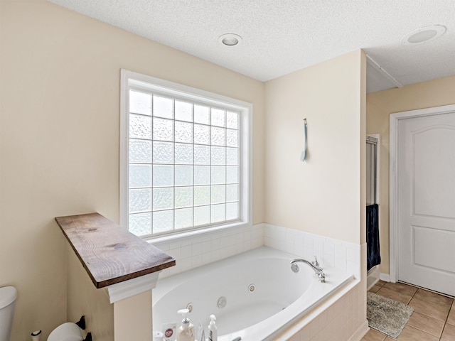 bathroom featuring shower with separate bathtub, a textured ceiling, tile patterned floors, and plenty of natural light